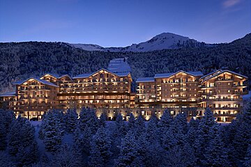 A large building in the middle of a snowy forest