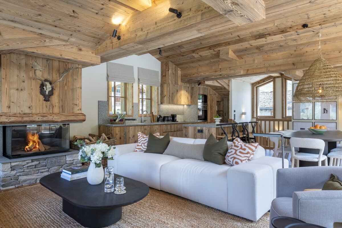 A living room with a white couch and a fireplace