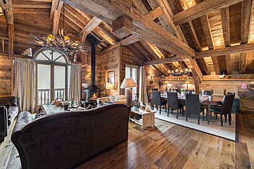 A living room and dining room in a wooden cabin
