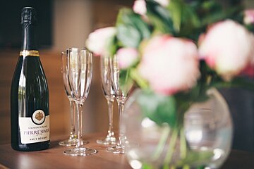 A bottle of pierre spare champagne sits on a table
