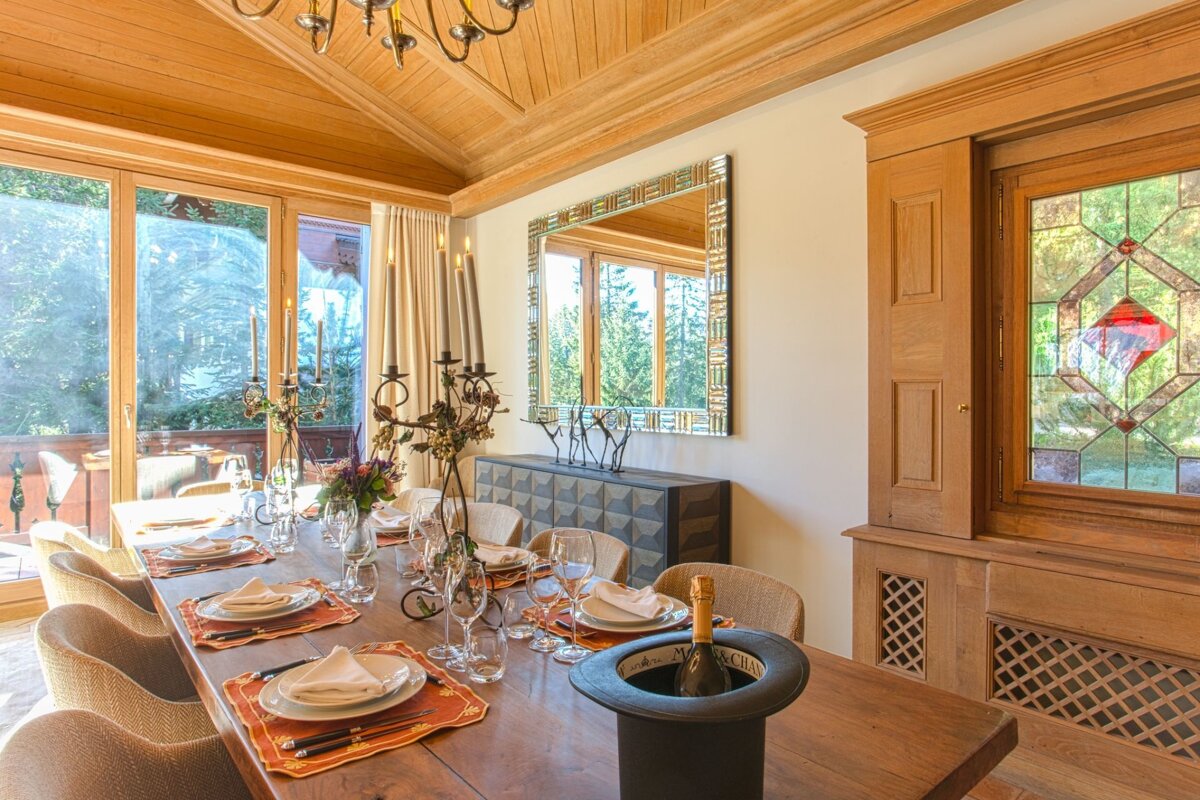 A dining room with a stained glass window and a mirror