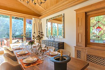 A dining room with a stained glass window and a mirror