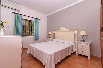 A bedroom with a large bed and two nightstands