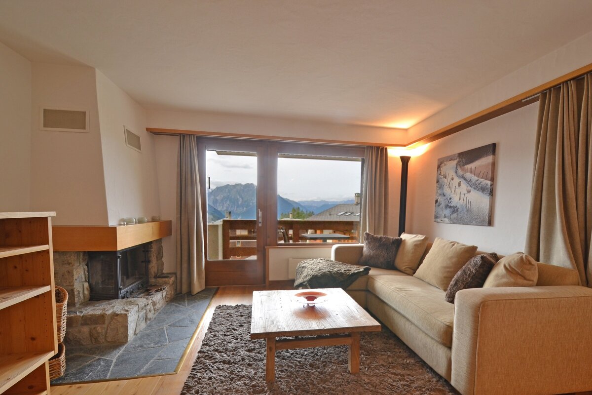 A living room with a couch and a fireplace