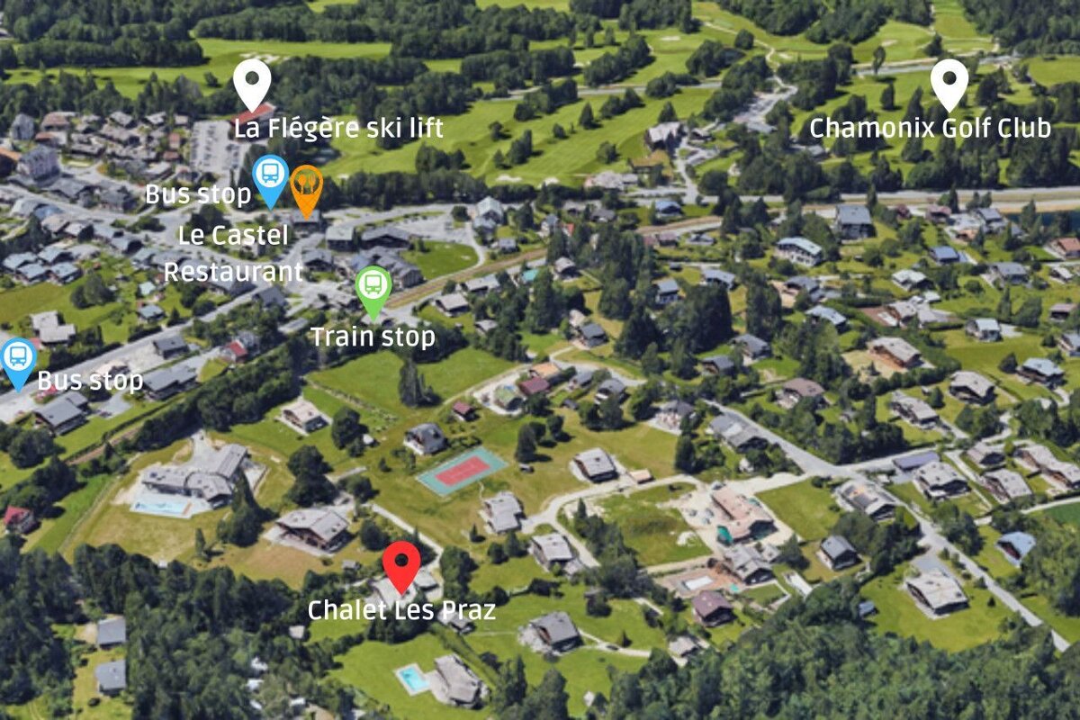 An aerial view of a residential area with a red circle in the middle that says chalet les praz
