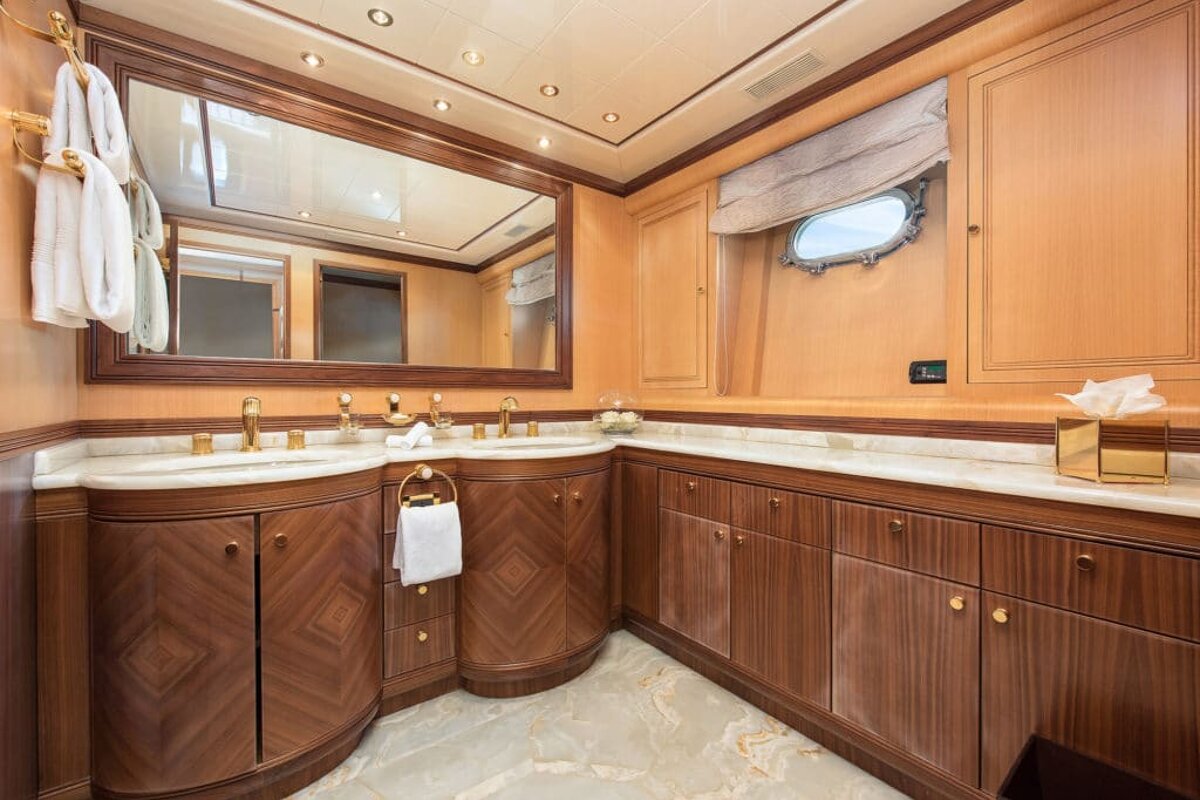 A bathroom with two sinks and a large mirror