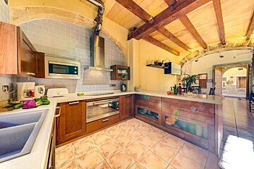 A kitchen with wooden cabinets and stainless steel appliances