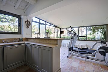 A gym with a treadmill and an elliptical