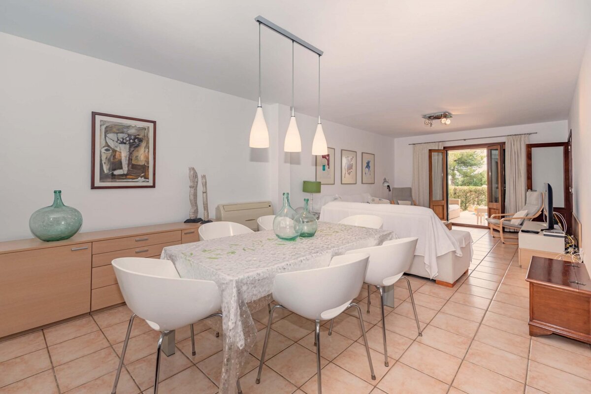 A living room with a dining table and chairs
