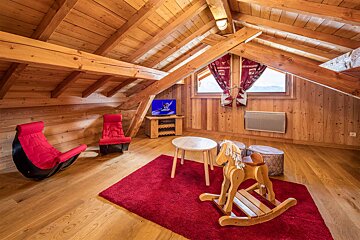 A wooden room with a rocking horse on the floor