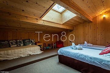A bedroom with two beds and the word ten80 on the wall