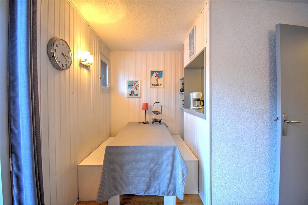 A room with a table and a clock on the wall