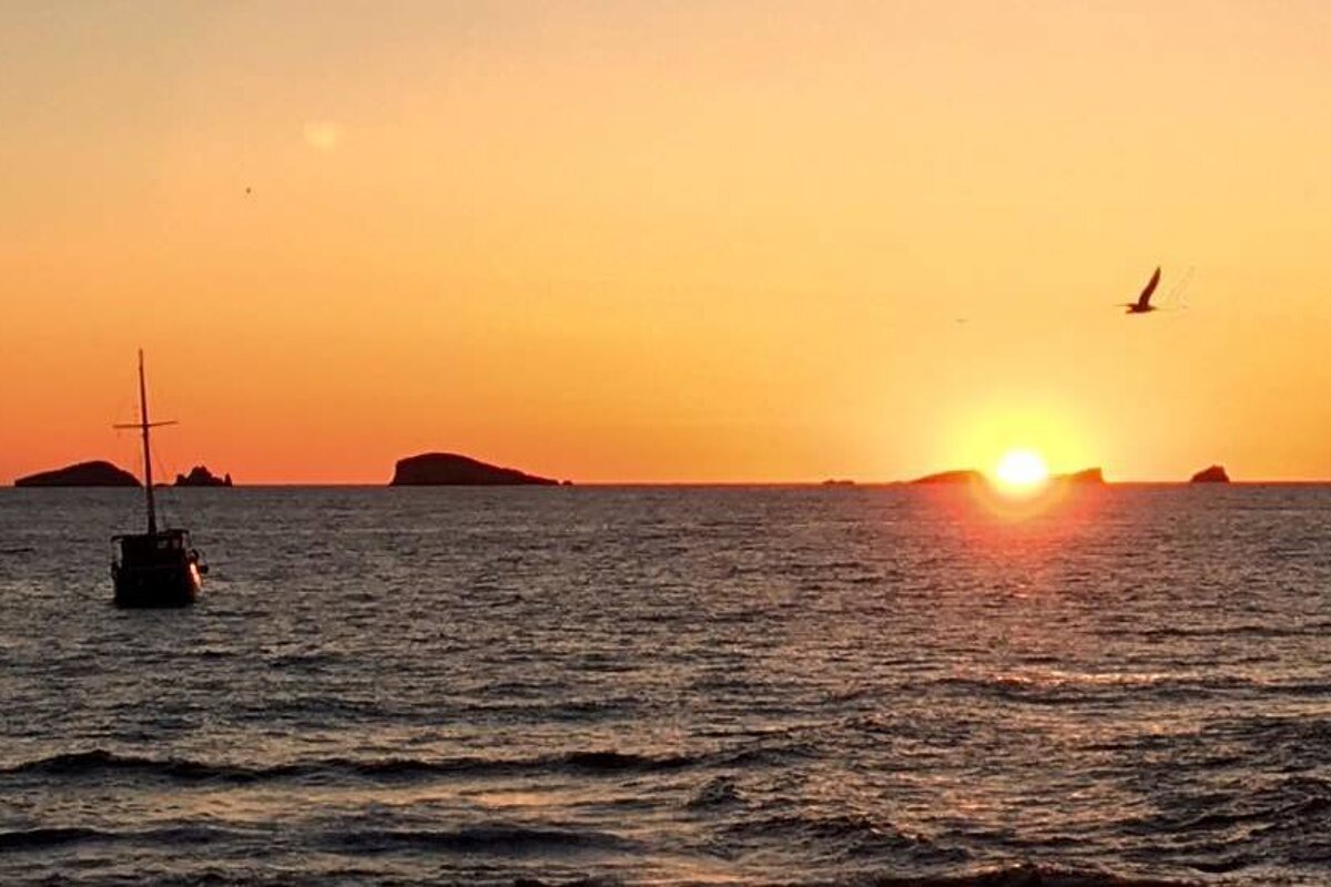 The sunset from a boat in san antonio bay ibiza