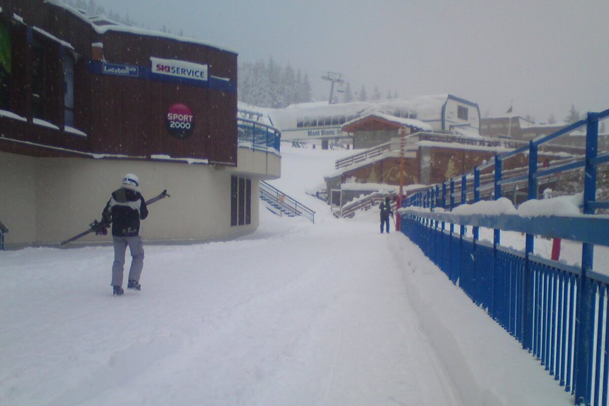 a skier carrying skis in les arcs