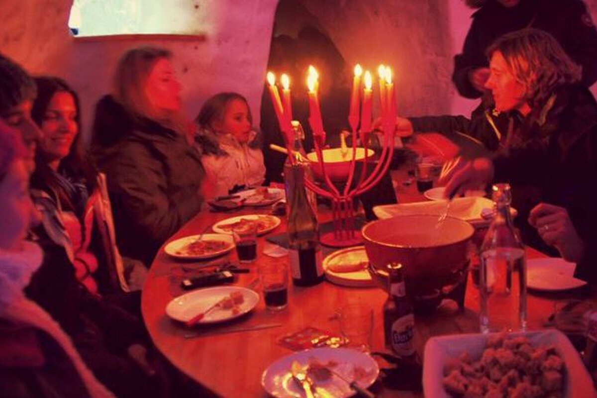 people having dinner in an igloo
