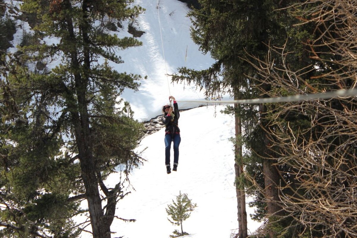 a woman on a zipline in la plagne