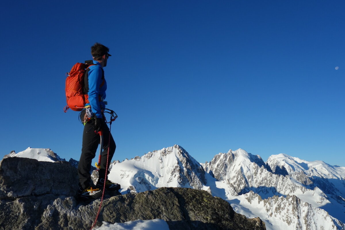 mountaineer standing on the aiguille du tour looking over to mont blanc