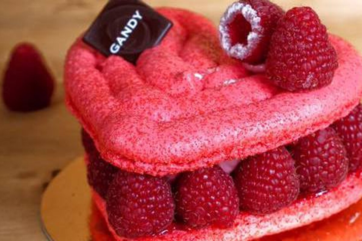 a heart shaped cake with rapserries