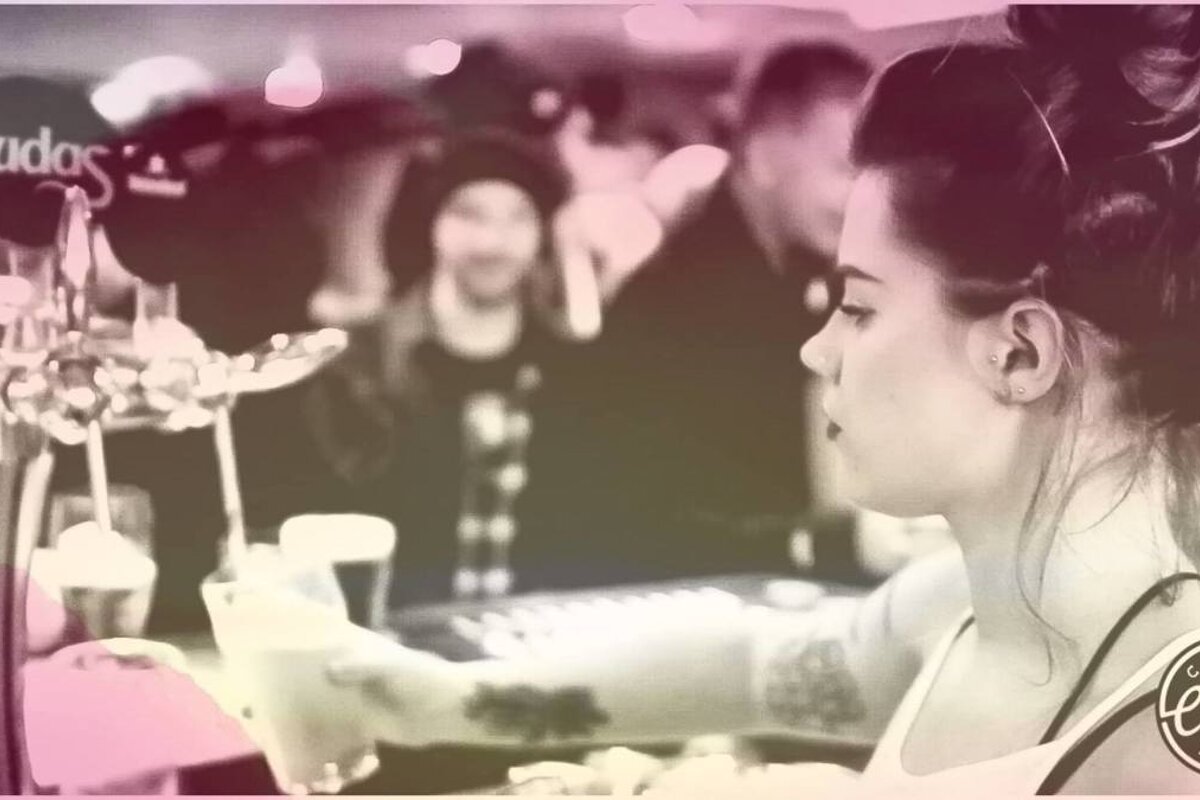 a waitress pouring drinks in a bar