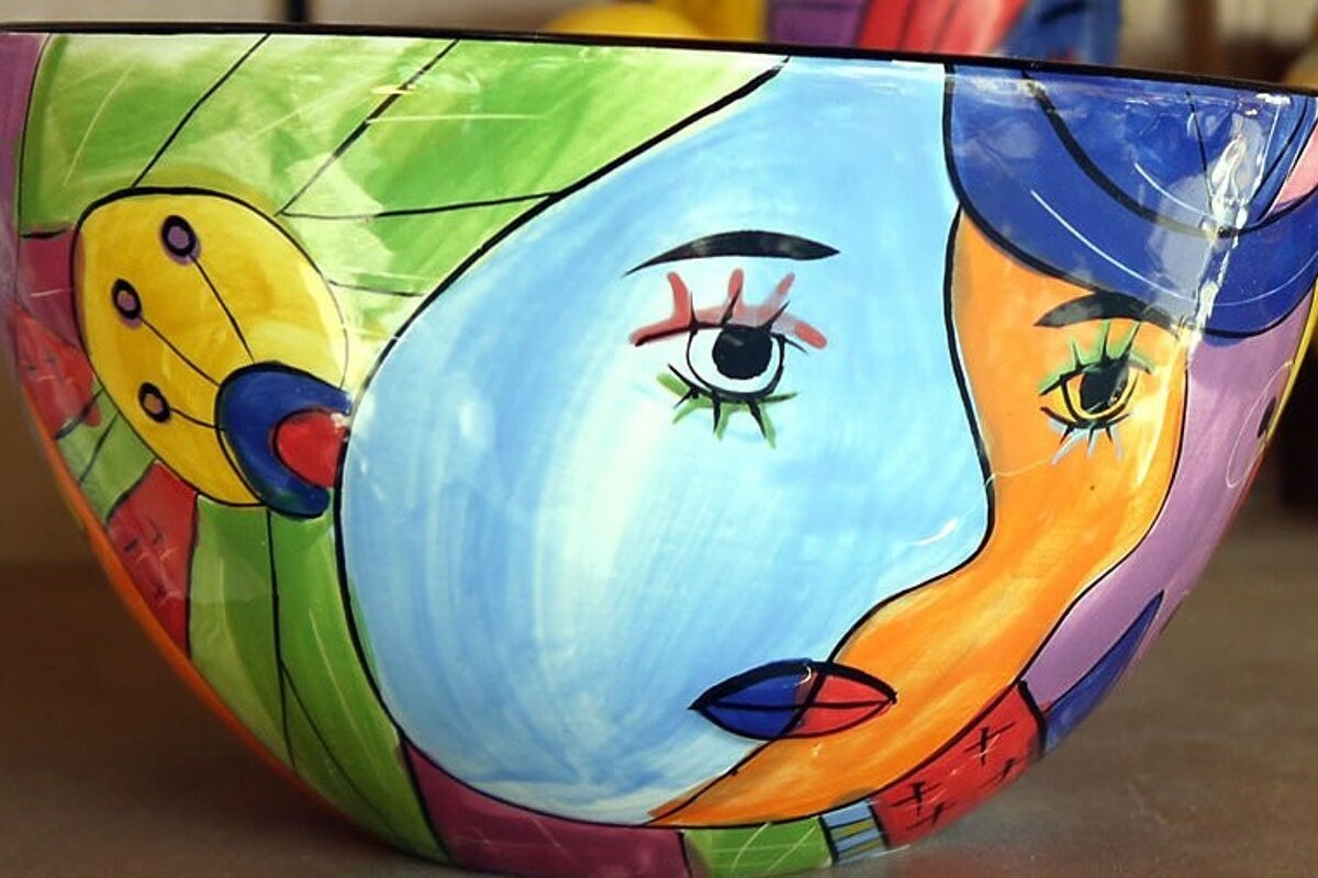 a ceramic bowl with picasso style painting