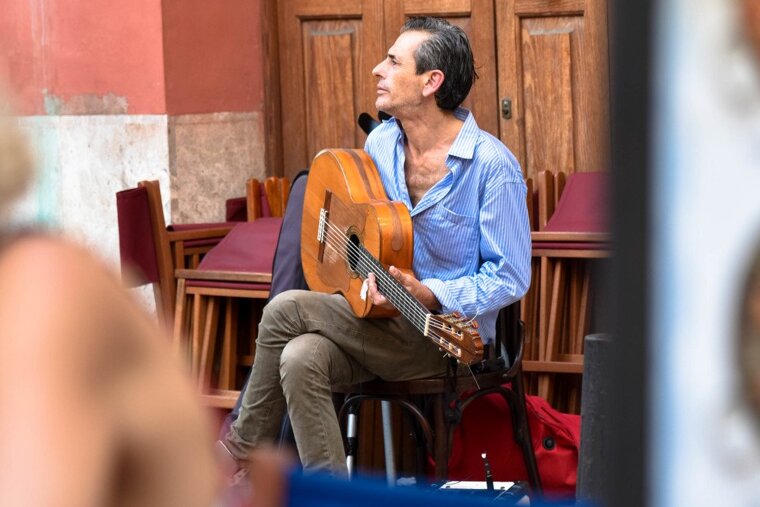 A local playing the guitar in the street