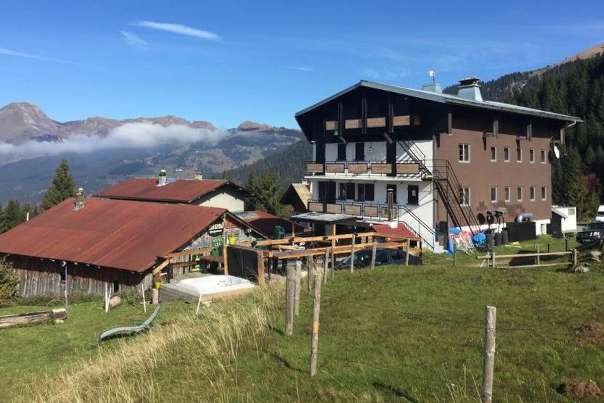 A mountain hotel and terrace in summer