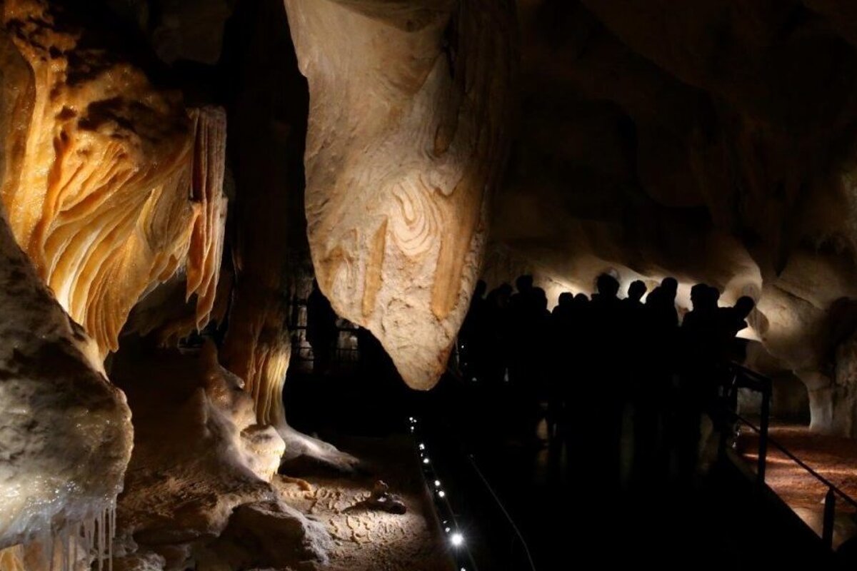 visitors in a cave reconstruction