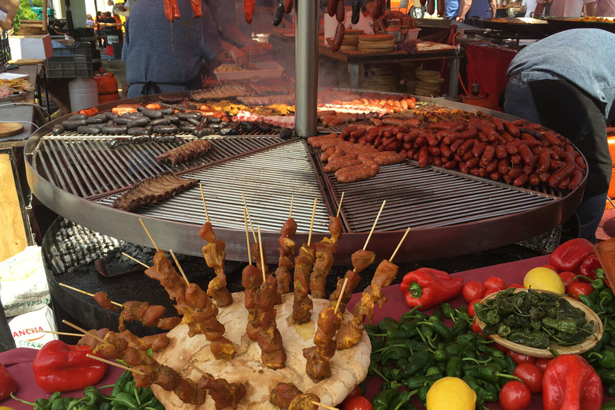 meats being grilled on a stall at capdepera medieval fair in Mallorca