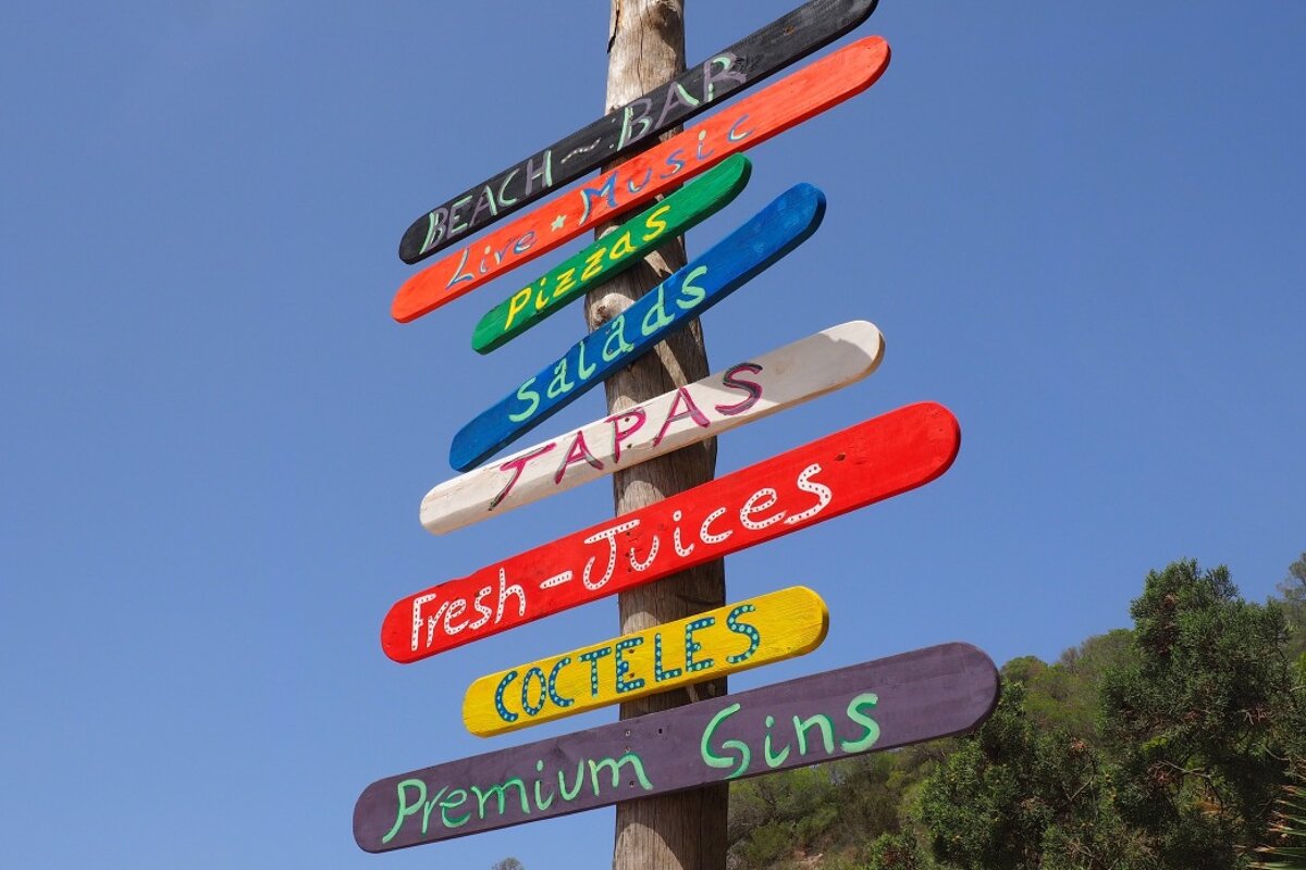 a signpost for the bars of cala vadella in south west ibiza