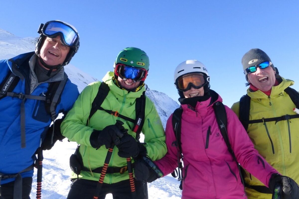 four happy skiers