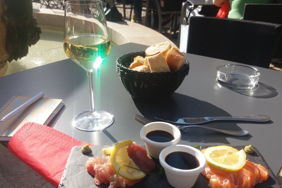 a glass of wine and some tapas