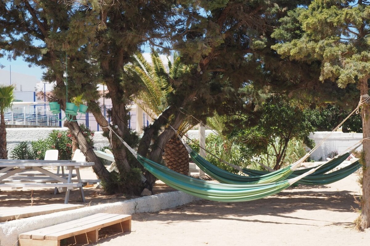 hammocks stretched out at beach star lounge at punta xinxo ibiza