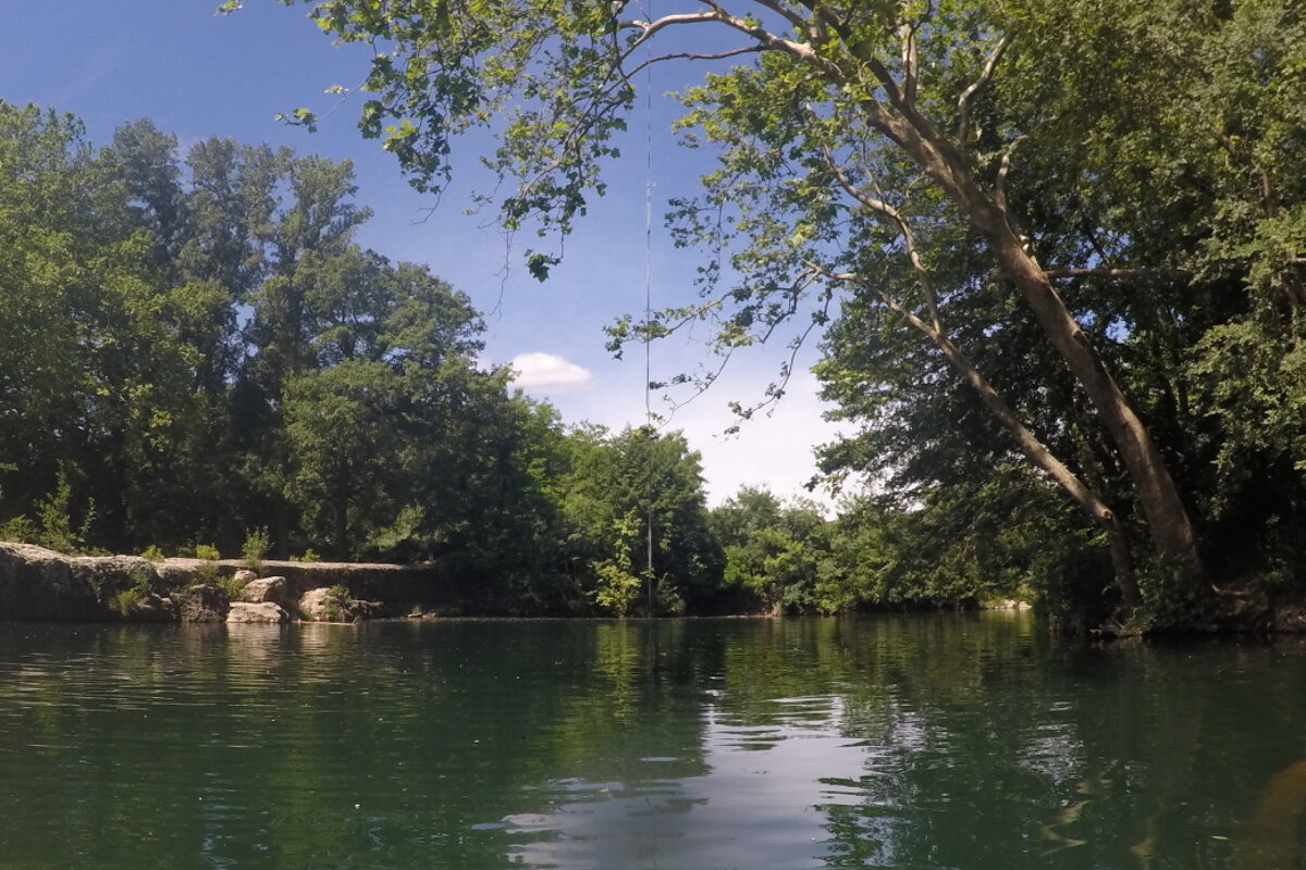 the rope swing at a swimming pool on the river ceze in provence