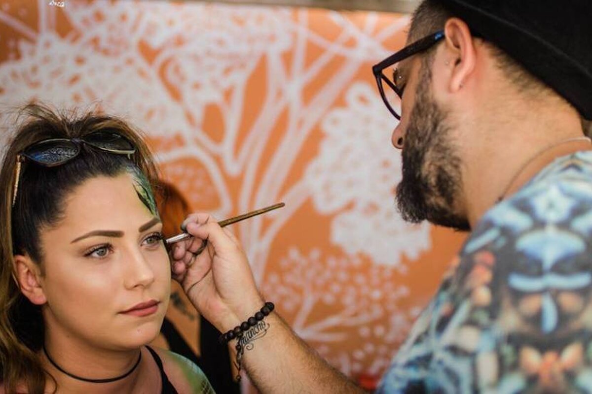 a girl getting facepaint on at the zoo project san antonio ibiza