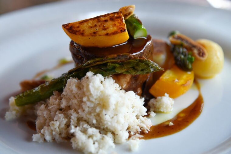 Mallorcan leg of lamb filled with figs, cauliflower cous cous and juniper berry sauce