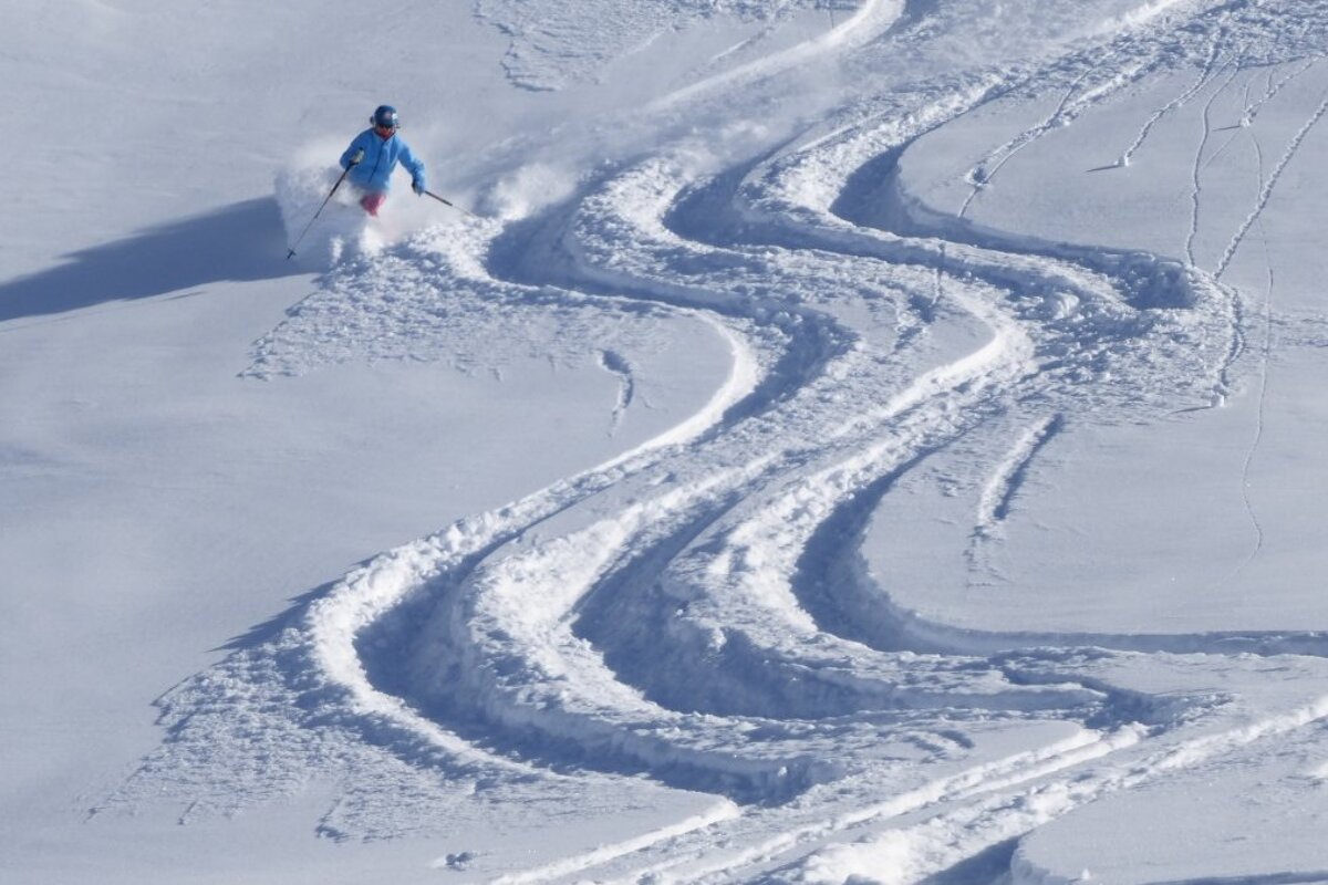 a woman skiing off piste in Val d'Isere