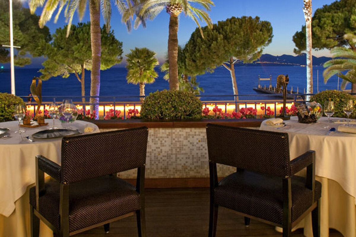 the terrace of the Palme d'Or restaurant in cannes overlooking le Croisette