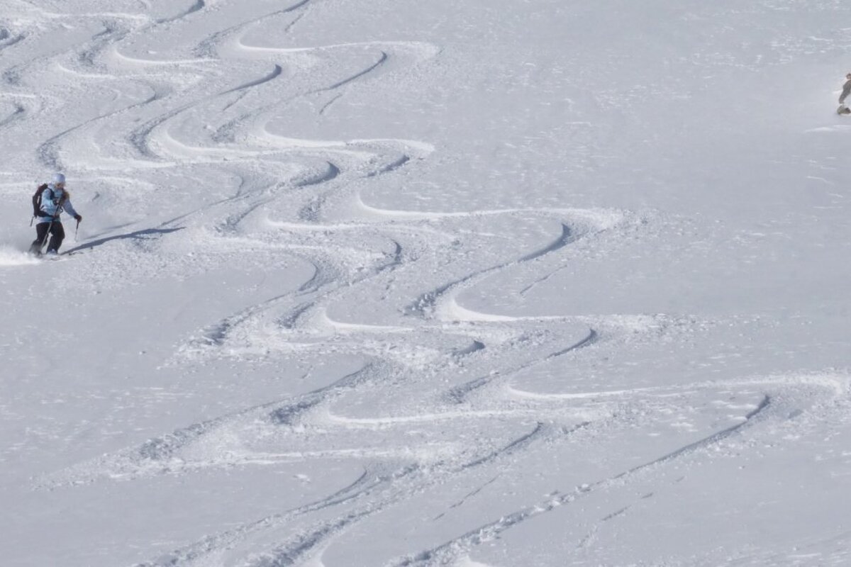 a skier making parallel lines
