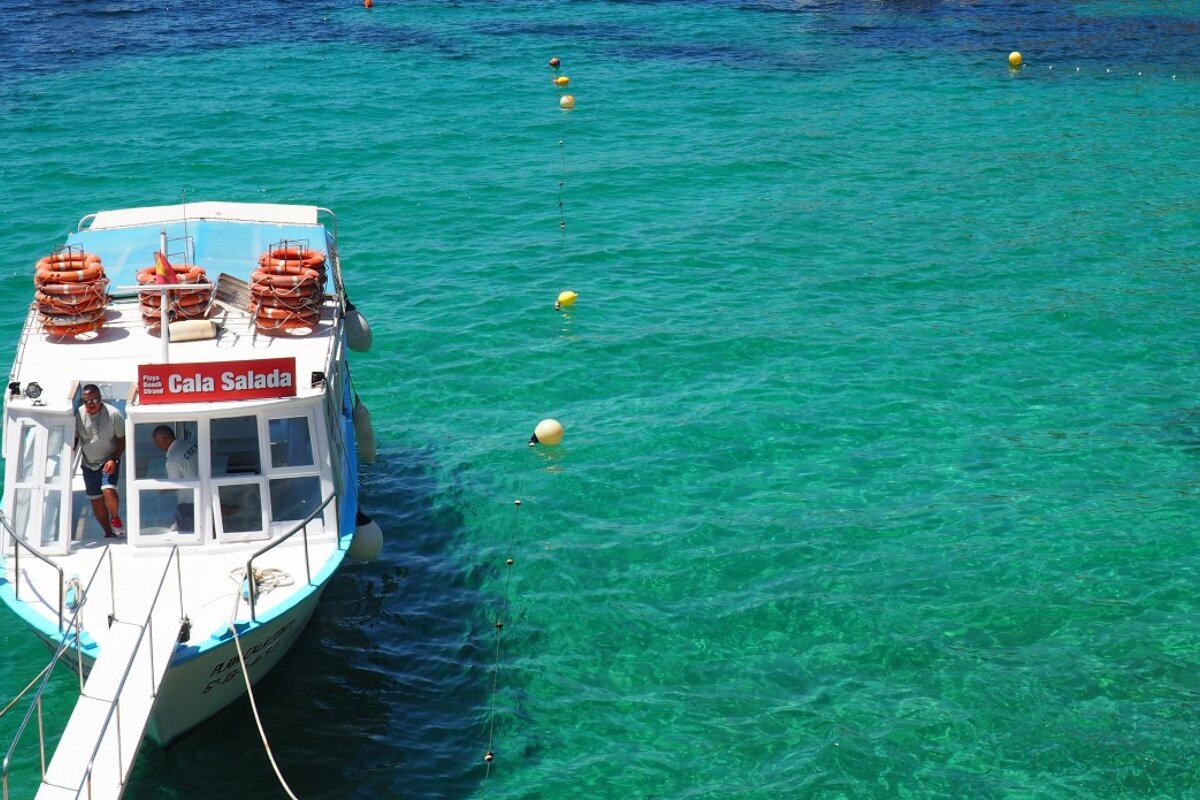 Ferry in clear blue water at cala salada in west ibiza