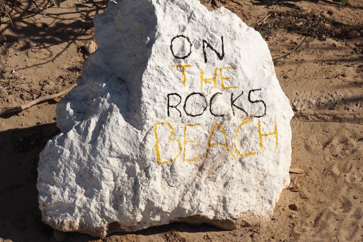 a boulder with words on it at playa pinet ibiza