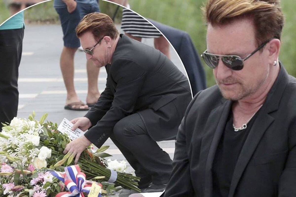 Bono laying down a flower tribute to those who died in Nice