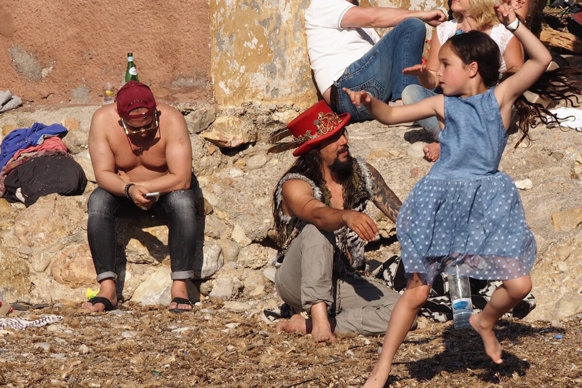 child dancing freely on benirras beach ibiza