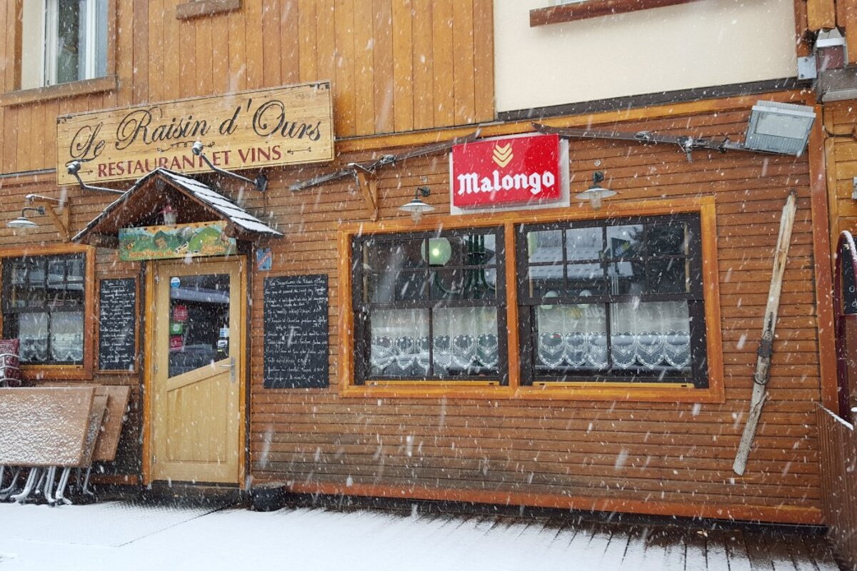 the outside of a restaurant in 2alpes in the snow