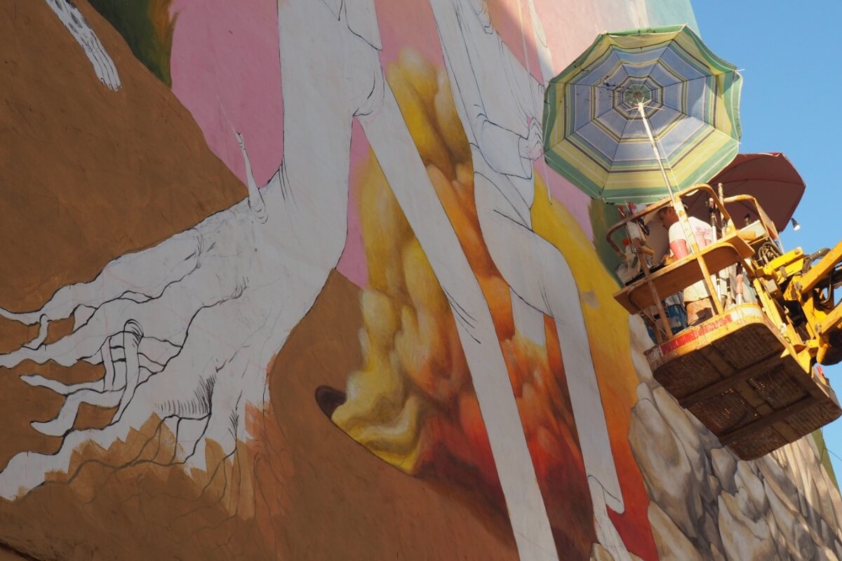 artist works on a new piece on a wall in san antonio