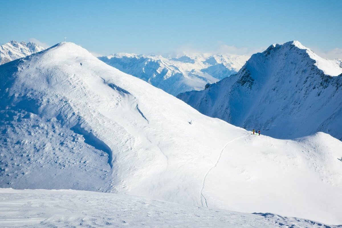two ski tourers on a ridge line