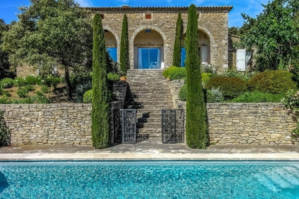 a stone house and pool