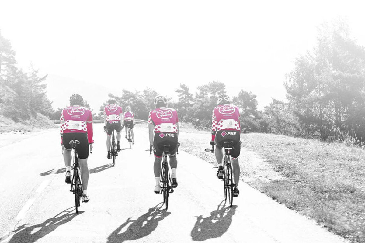 cyclists in pink jerseys