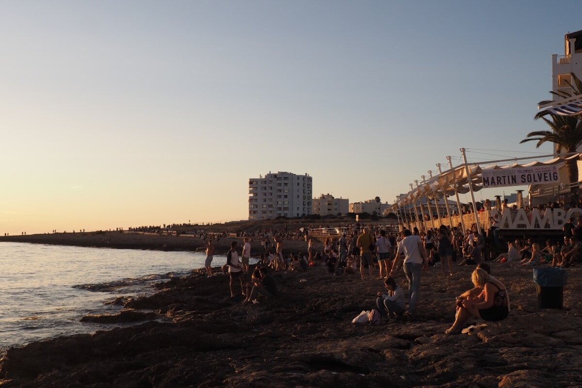 crowds sitting in front of cafe mambo in san antonio ibiza