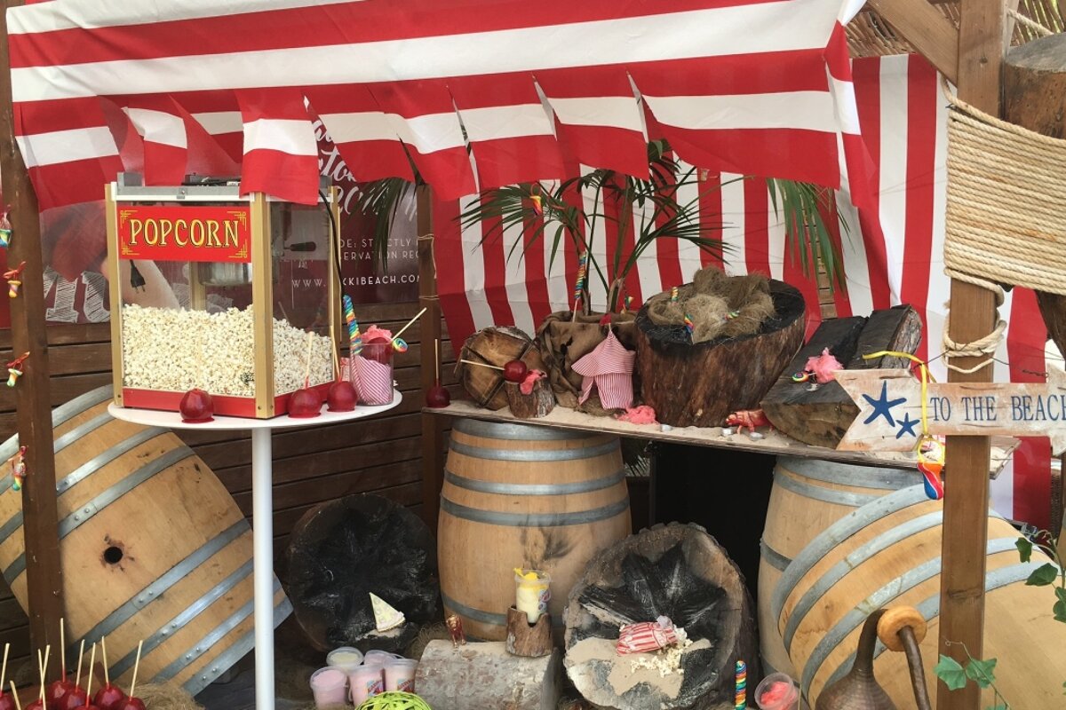 a stall with popcorn & toffee apples at nikki beach circus party mallorca