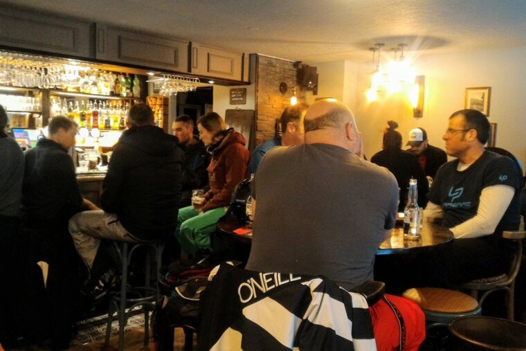 Skiers and snowboarders relaxing in the bar